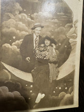 Load image into Gallery viewer, Man & Woman Sitting Paper Prop Moon Dated 1916 Antique Photo RPPC