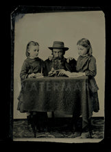 Load image into Gallery viewer, tintype man & Girls holding open watch or photo locket 1800s Unusual Mourning?