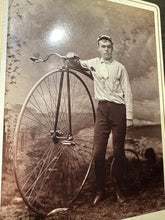 Load image into Gallery viewer, Antique Cabinet Card Cyclist in Racing Uniform Posing with High Wheel Bicycle
