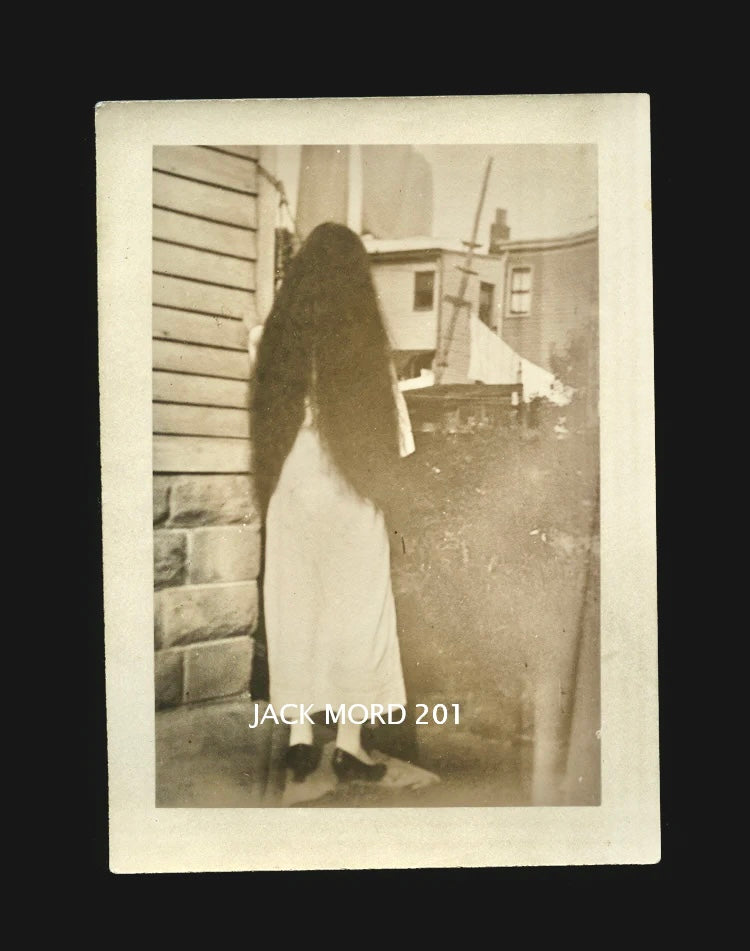 creepy unusual old snapshot photo long black hair girl turned away from camera