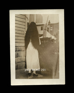 creepy unusual old snapshot photo long black hair girl facing away from camera
