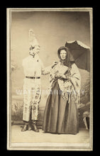 Load image into Gallery viewer, weird 1860s cdv photo dunce or clown &amp; woman with parasol torn painted backdrop
