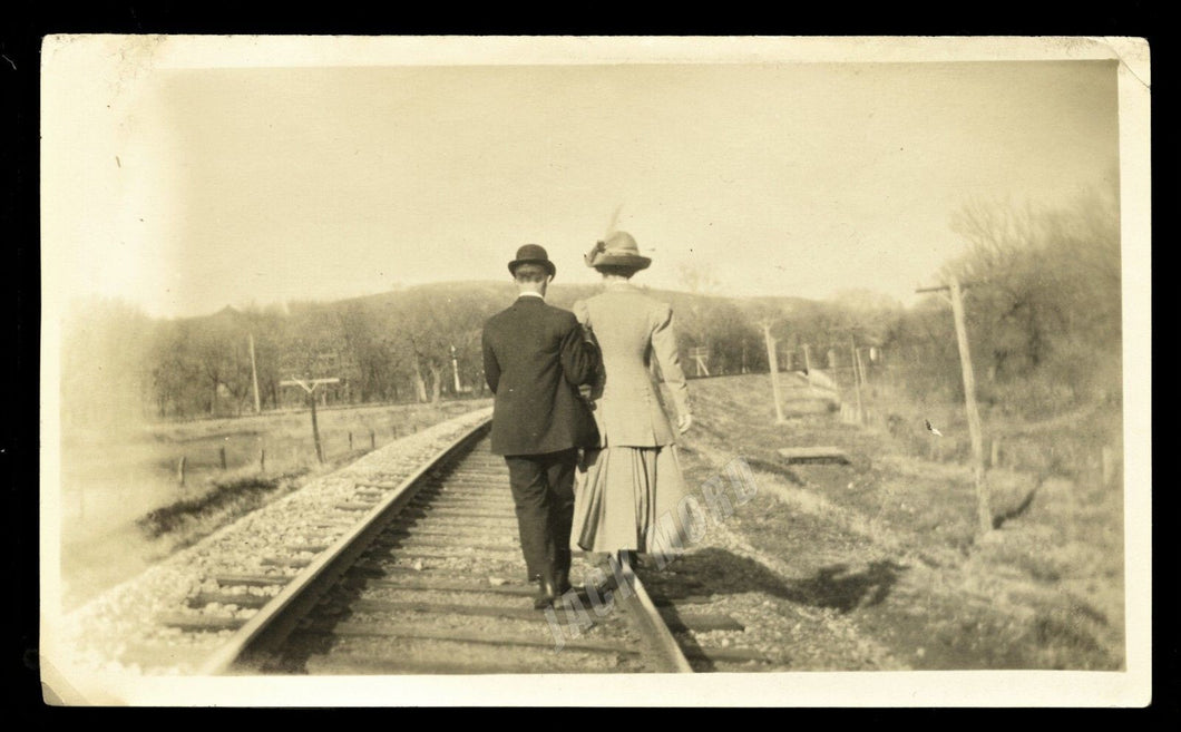 man & woman on train tracks back to photographer ~ artistic old snapshot photo