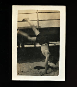 cartwheel acrobat - vintage snapshot man in bathing suit on beach / action photo
