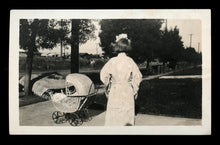 Load image into Gallery viewer, snapshot photo girl turned away from camera with doll stroller, unusual creepy
