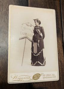 Banner Lady Cabinet Card - Decorated Dress & Holding Lumber Sign